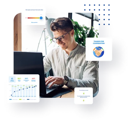 A man works on a laptop surrounded by data visualizations and business graphics.